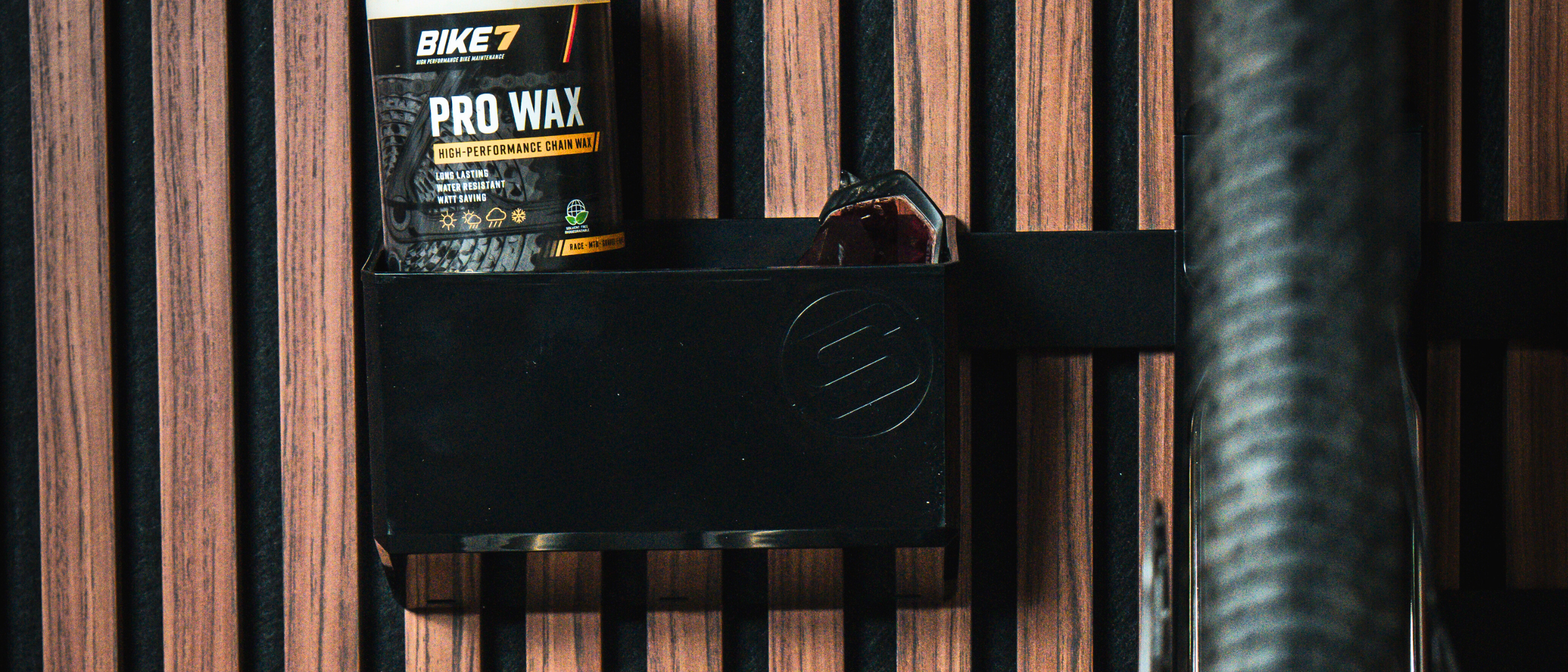 Bicycle mounted on a wall bracket with a wooden background