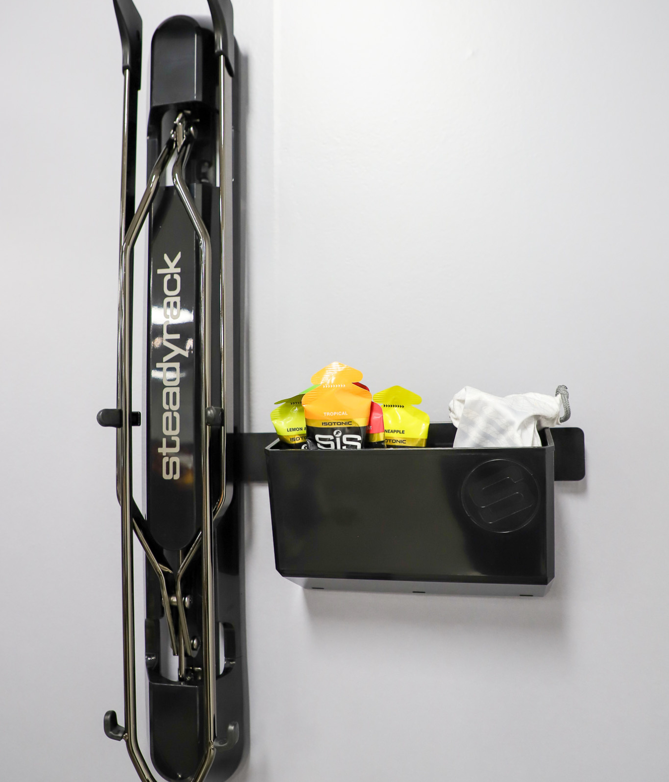 Black bike rack with a storage compartment on a white background