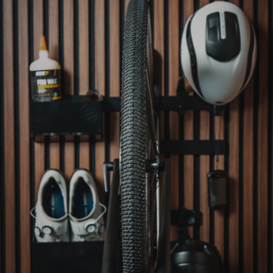 Bicycle tire, helmet, shoes, and glue on a wooden shelf
