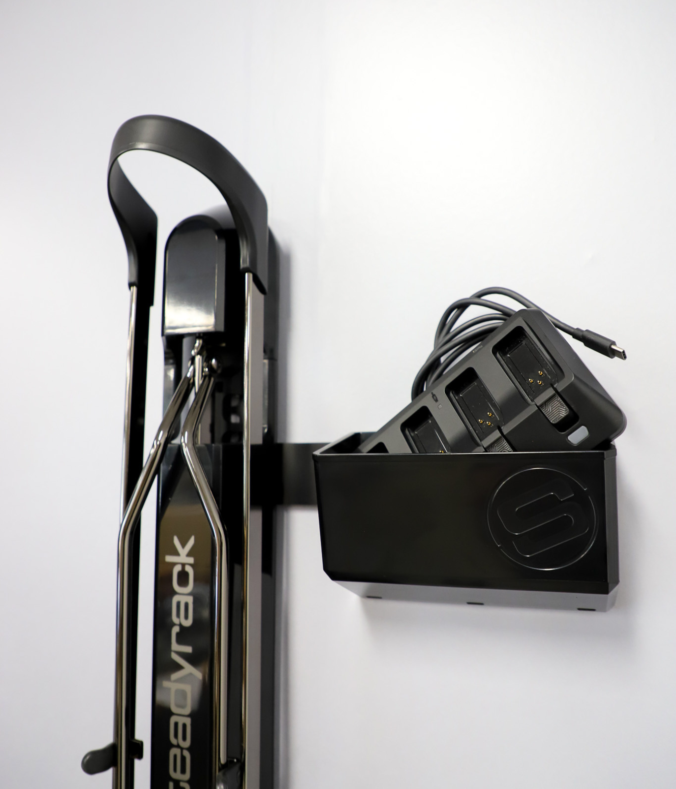 Steadyrack bike rack with a storage bin holding a power station on a white background